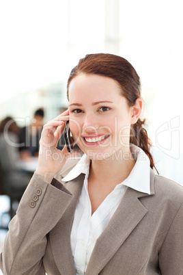 Cute businesswoman on the phone in the foreground
