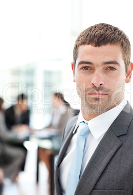 Charismatic businessman standing in the foreground