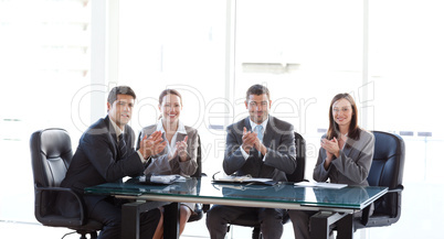 Cheerful businessteam applauding during a presentation