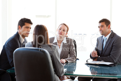 Rear view of a businesswoman being interviewed by three executiv
