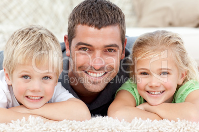 Adorable family sitting on the sofa and smiling at the camera