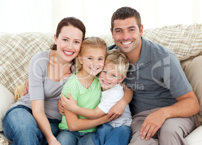 Happy family sitting on the sofa