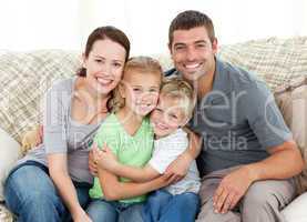 Happy family sitting on the sofa