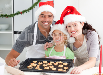 Happy woman with husband and daughter ith their biscuits ready