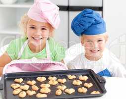 Happy little brother and sister with their biscuits ready to eat