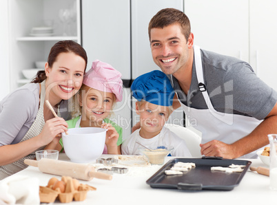 Portrait of a joyful family cooking littles cakes