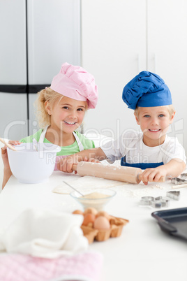 Cute sibling baking cookies together in the kicthen