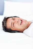 Handsome man laughing while listening music