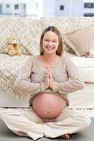 Portrait of a cute pregnant woman doing yoga