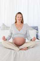 Pretty pregnant woman doing yoga