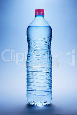 Bottle with water on a blue background
