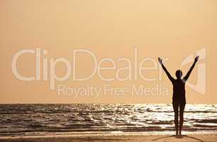 Successful Woman Arms Raised At Sunset on Beach