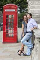 Romantic Couple by Traditional Red Phone Box in London, England