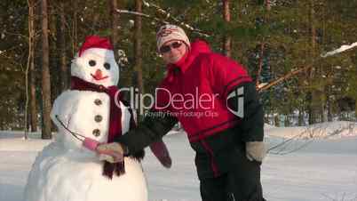 Woman poses with snowman