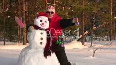 Woman poses with snowman