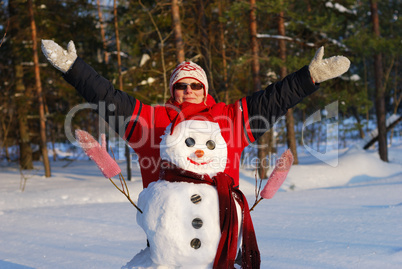 Woman poses with snowman