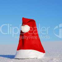 Traditional Santa hat on winter background