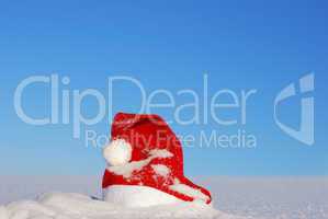 Traditional Santa hat on winter background