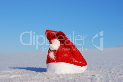 Traditional Santa hat on winter background