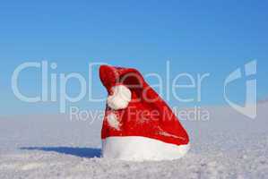 Traditional Santa hat on winter background