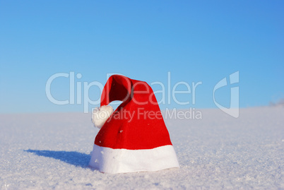 Traditional Santa hat on winter background