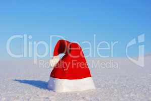 Traditional Santa hat on winter background