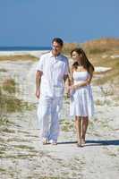 Romantic Couple Walking Holding Hands on An Empty Beach