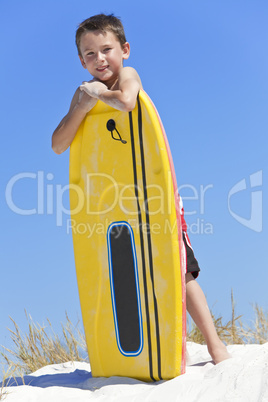 Young Boy Child With Surfboard At The Beach