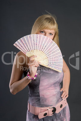 Beautiful young woman with fan