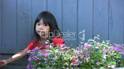 Asian Girl Watering Pretty Flowers