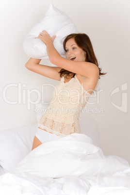 PIllow fight - young woman in bed