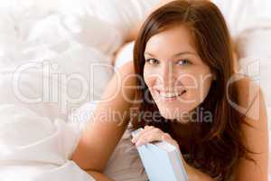 Bedroom - young happy woman with book