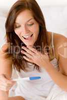 Pregnancy test - happy surprised woman