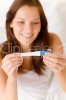 Pregnancy test - happy surprised woman