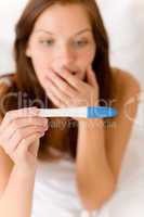 Pregnancy test - happy surprised woman