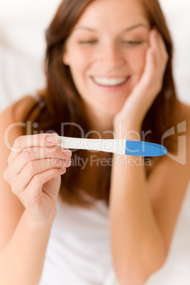 Pregnancy test - happy surprised woman