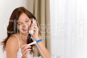 Pregnancy test - happy woman on phone