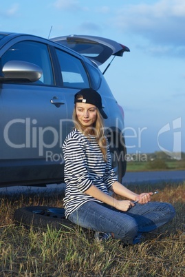 Young Blond Woman With Her Broken Car