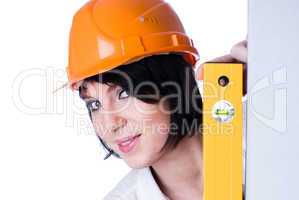 Woman in helmet with level