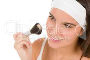 Skin care - young woman apply powder
