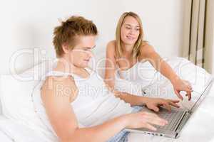 Bedroom - young couple with laptop