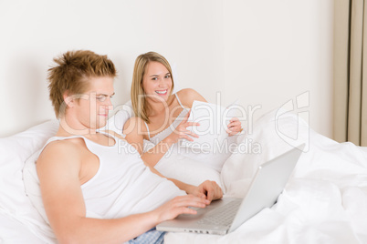 Bedroom - young couple with laptop and book