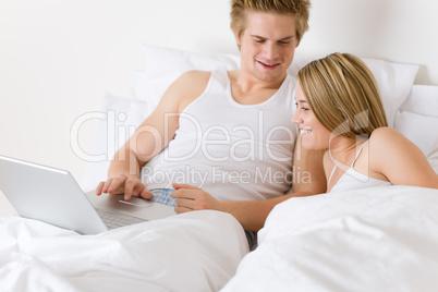 Bedroom - young couple with laptop