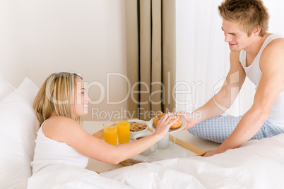 Luxury hotel honeymoon breakfast - couple in bed