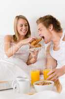 Luxury hotel honeymoon breakfast - couple in bed