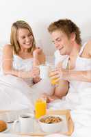 Luxury hotel honeymoon breakfast - couple in bed