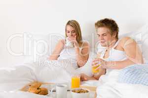 Luxury hotel honeymoon breakfast - couple in bed