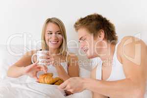 Luxury hotel honeymoon breakfast - couple in bed