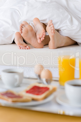 Luxury hotel honeymoon breakfast - couple in bed