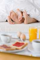 Luxury hotel honeymoon breakfast - couple in bed